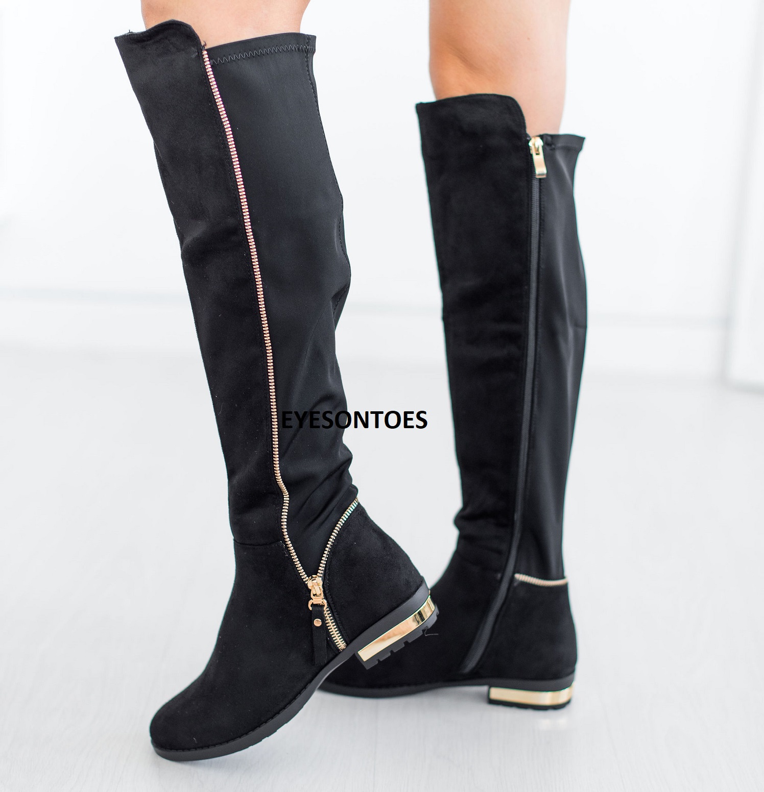 black over the knee boots with gold zipper